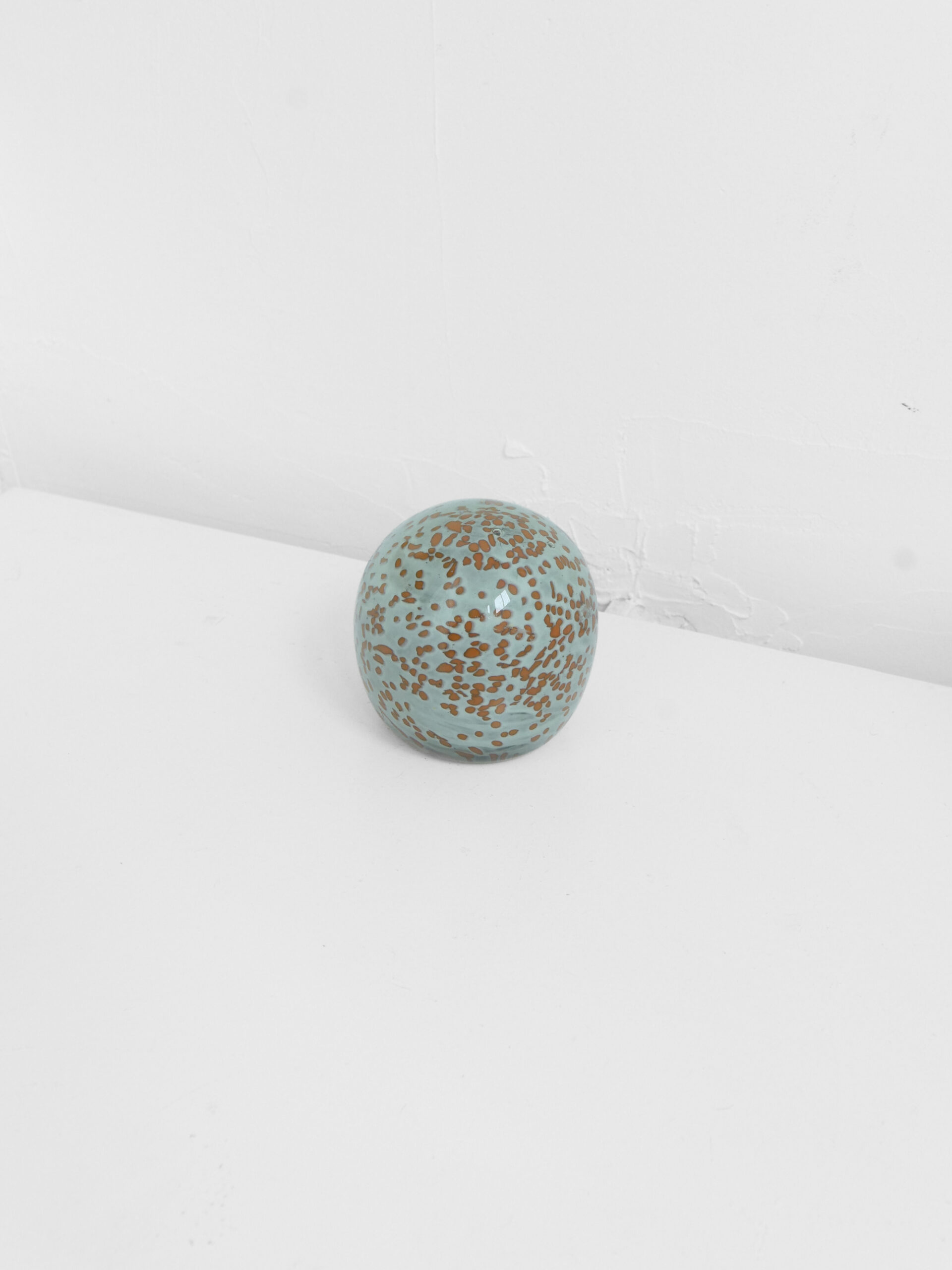 Blue-green glass paperweight